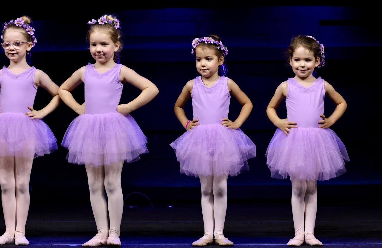 Dancers performing together on stage at the recital