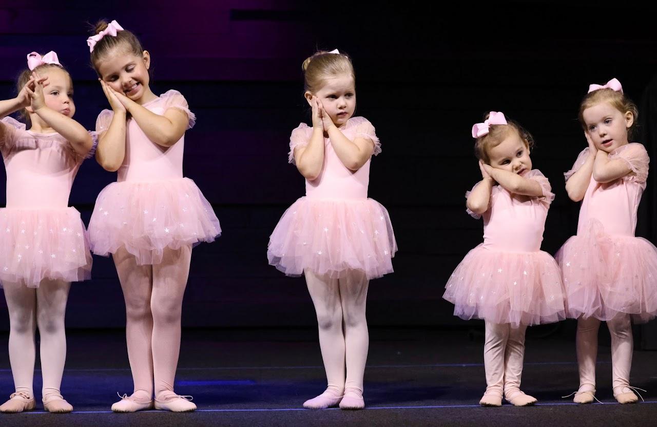 Dancers lined up together on stage during a recital